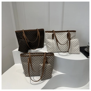 Three large tote bags in brown, beige, and grey with geometric patterns and long straps