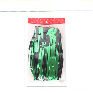 Detail of green and black foil fringe curtain in retail packaging for party background deco
