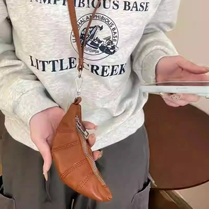 Neck-hanging brown croissant shaped mini coin purse with silver zipper and metal clasp