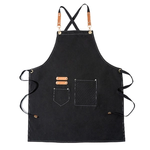 Custom black canvas work apron with brown leather straps and multi-pocket design for baristas