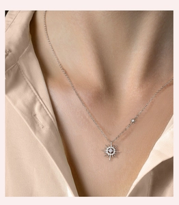 Close-up of S925 sterling silver hexagram necklace with moissanite on a female model