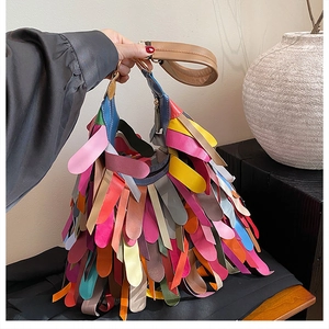 Detail of colorful layered leather tassels and broad strap on Bohemian hobo bag