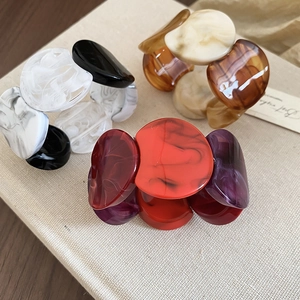 Detailed view of thick acrylic bangles with marble texture in various colors
