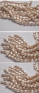 Detailed view of light pink irregular baroque pearls with high luster on white background