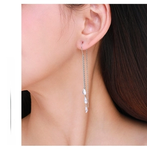 Close-up of elegant S925 silver tassel earrings with three teardrop cubic zirconia stones