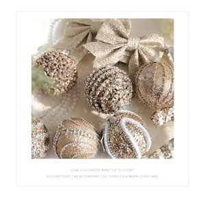Close-up of champagne gold Christmas ornaments and bows with glitter and pearls