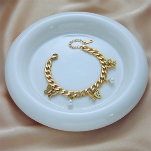 Gold stainless steel chain bracelet with butterfly pendant and white pearl accents