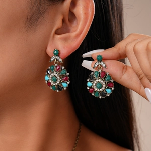 Detailed close-up of retro floral stud earrings with multi-color rhinestones