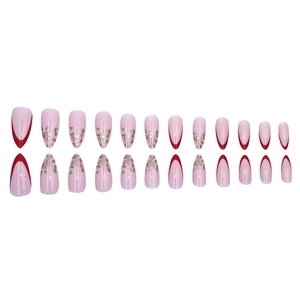 Close-up of almond press-on nails with red French tips and gold foil accents