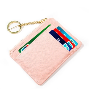 Detailed macro view of pink litchi grain card holder with gold zipper and keychain