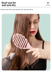 Pink vented hair brush used by a model for wet and dry styling with a blow dryer