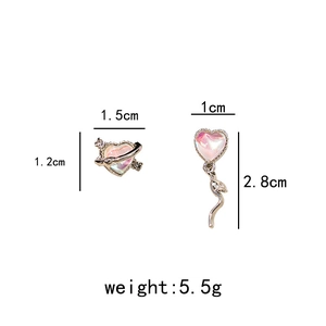 Detail of asymmetric heart earrings with fringe and orbital design showing exact dimensions