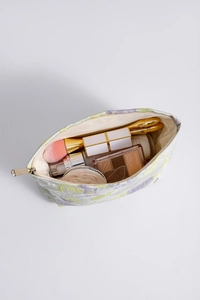 Internal view of floral makeup bag showing large capacity for brushes and cosmetics
