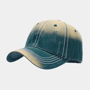 Detailed side view of washed gradient baseball cap with distressed edge and thick stitching