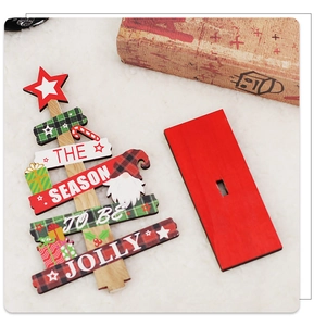 Detail of wooden Christmas tree tabletop decor with festive gnome and plaid patterns