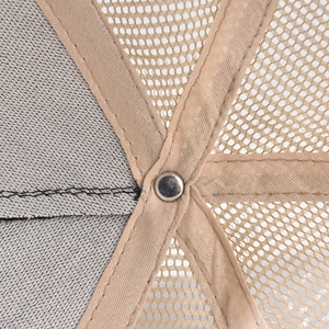 Detailed interior view of a trucker hat showing reinforced stitching and metal rivets