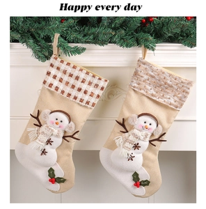 Detail of two Christmas stockings with snowman applique hanging on a fireplace