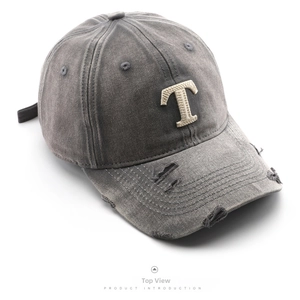 Top view of washed grey cotton baseball cap with vintage distressed holes and T embroidery