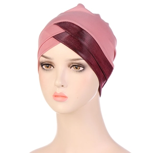 Detail of cross-knot design on pink turban hat with metallic burgundy fabric accents