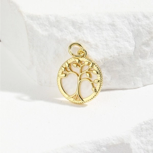 Detailed view of a golden tree of life pendant featuring an iridescent mother of pearl inlay