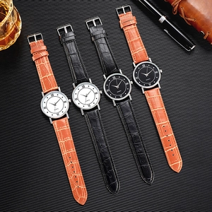 Business quartz watches with leather straps and Roman numeral dials in professional setting