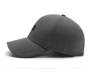 Close-up of dark grey baseball cap showing breathable fabric texture and side label