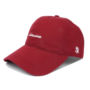 Détail macro de la casquette de baseball en sergé bordeaux avec broderie blanche