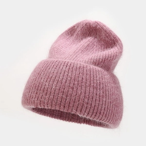 Detail of soft pink angora wool knit beanie with thick vertical texture and fuzzy finish
