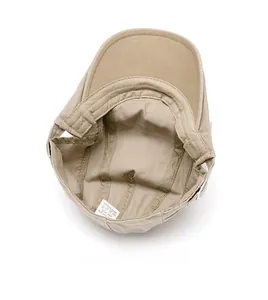 Detail view of khaki cotton flat cap interior featuring neat stitching and soft sweatband