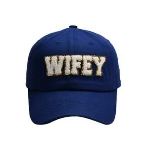 Detail of navy blue baseball cap featuring WIFEY chenille embroidery and gold trim
