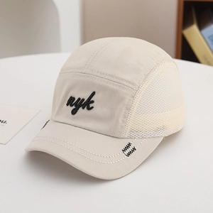 Detail of beige five-panel baseball cap with mesh side panels and nyk embroidery