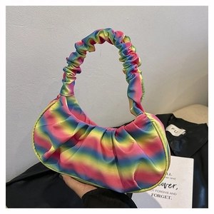 Detail shot of rainbow gradient pleated shoulder bag with vibrant textured fabric