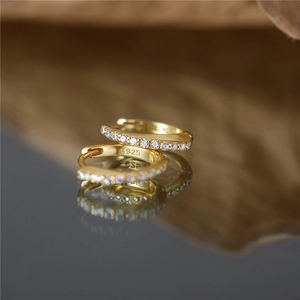 Macro detail of S925 sterling silver gold earrings with zircon stones and hallmark