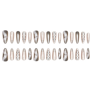 French almond press-on nails with silver metallic bows and navy blue polka dots