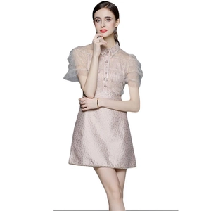 Elegant light pink dress featuring lace mesh sleeves and a pleated bow tie neckline
