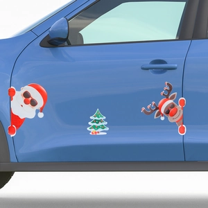 Close-up of reflective Santa and reindeer magnetic car stickers on a blue door