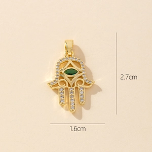 Detailed size view of golden Hamsa Hand pendant with zircon stones, 2.7cm by 1.6cm