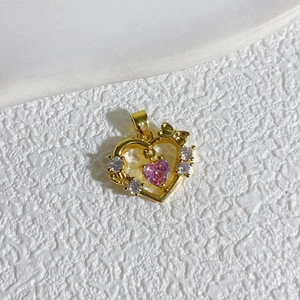 Elegant 18K gold plated heart pendant with pink crystal and bow on white background