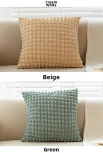 Close-up of textured bubble fabric on square throw pillows in cream and green tones