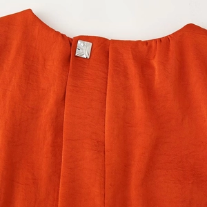 Elegant orange sleeveless satin dress with a square metallic button on the neckline