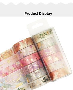 Close-up of 8-roll washi tape set featuring gold foil maple leaf and star patterns