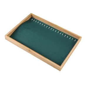 Bamboo jewelry display tray with dark green velvet lining for necklaces and bracelets