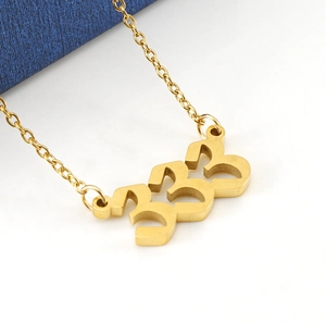 Close-up of golden number 333 pendant on O-chain stainless steel necklace