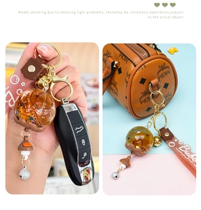 Creative oil wind chime keychain with mini mushroom charm and brown wrist strap