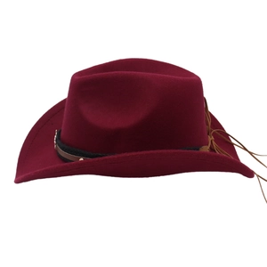 Detail of wine red felt cowboy hat featuring black decorative band and leather accents