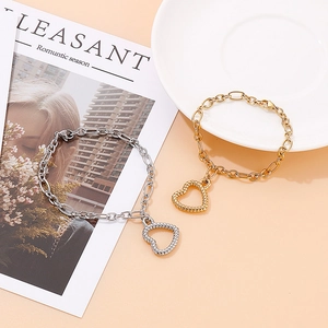 Fashion vintage hollow heart charm bracelet in gold and silver stainless steel finish