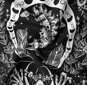Detailed macro view of gothic mountain tapestry fabric with skull and moon phase patterns