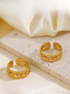 Close-up of gold 18K plated stainless steel V-shape rings with hollow moon star details
