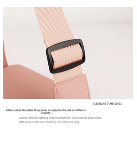 Detail of adjustable pink woven polyester shoulder strap with a black plastic buckle