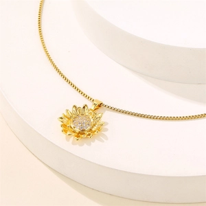 Golden sunflower necklace with sparkling zircon crystals on white elegant display base